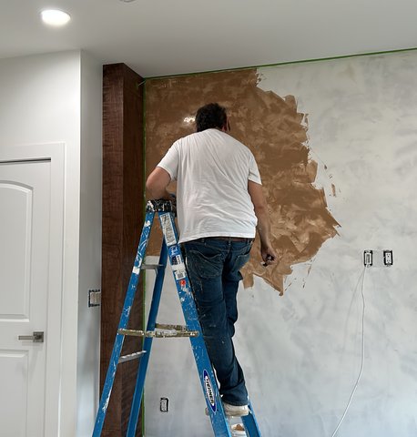 Romero on ladder applying Venetian plaster — Bergen County NJ