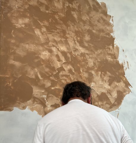 Close-up hand application of Venetian plaster