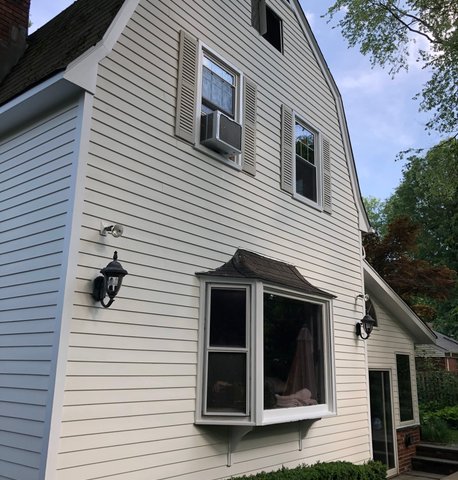 Exterior house painting finished — siding, trim and shutters complete