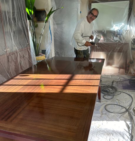 Dining table refinishing in progress — sanding and stain application