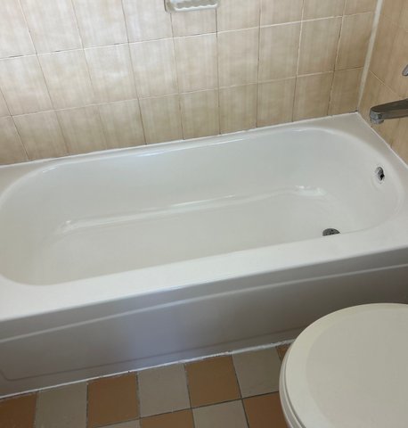 Bathtub after professional reglazing — bright gloss finish